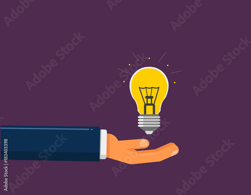 Hand holds the light bulb. Idea suggestion