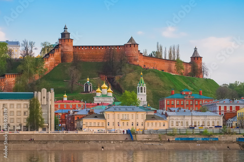 Nizhny Novgorod Kremlin and city buildings at sunset with the Volga River