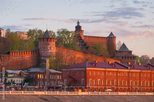 Nizhny Novgorod Kremlin and city buildings at sunset with the Volga River