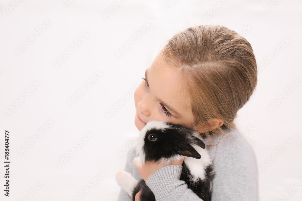 Cute girl with funny rabbit, indoors Cute girl with funny rabbit, indoors