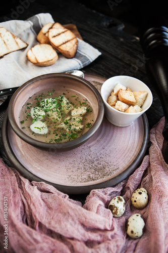 Chicken broth with quail eggs and croutons