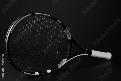 Tennis racket on dark grey background © Africa Studio