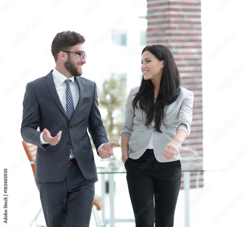 employees of the company discuss working issues standing in the office employees of the company discuss working issues standing in the office
