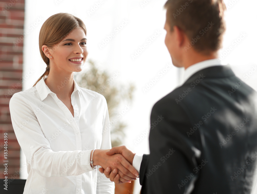 handshake young business woman with a colleague