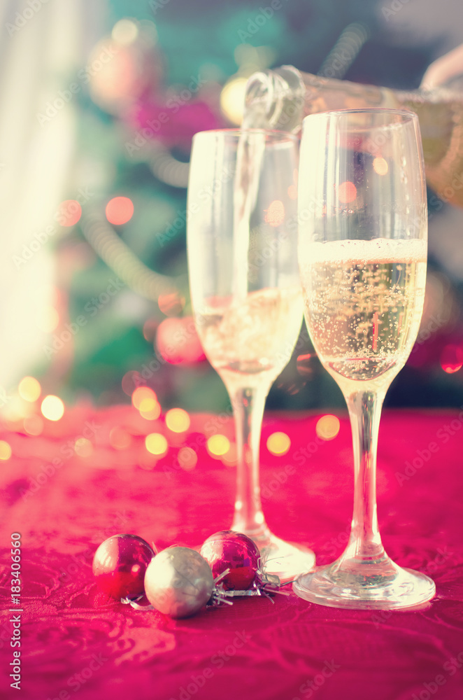 Two glasses of champagne near beautiful christmas tree Two glasses of champagne near beautiful christmas tree