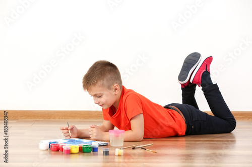 Cute boy painting picture o...