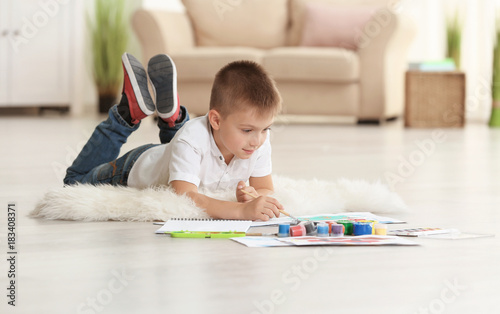 Cute boy painting picture o...