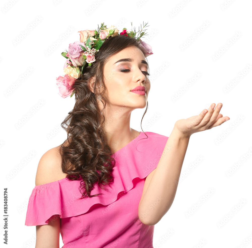 Beautiful young woman with floral perfume on white background