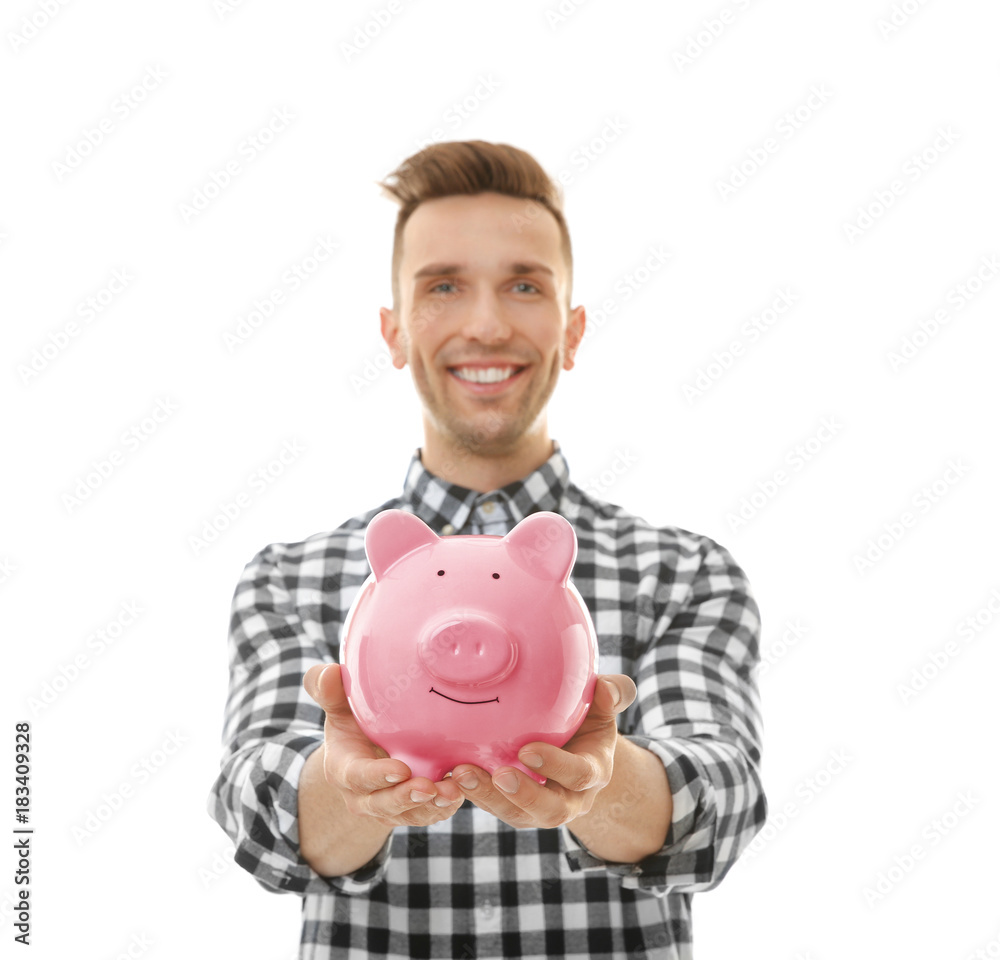 Young man with piggy bank on white background Young man with piggy bank on white background
