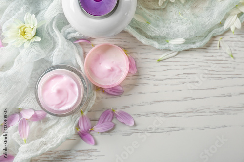 Beautiful composition with jar of body cream on wooden table