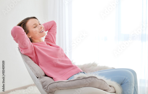 Happy young woman relaxing ...