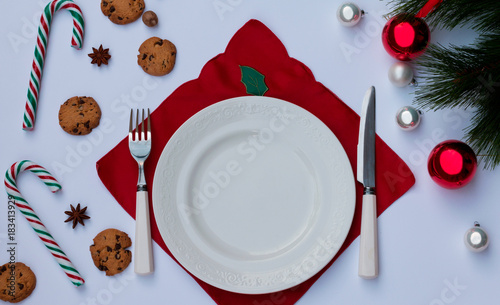Christmas table setting with copy space. A festive background of cutlery, cookie and Christmas decorations.