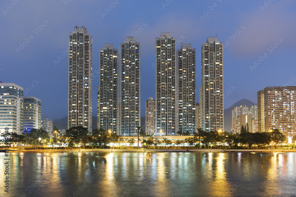 High rise residential building and river in Hong Kong city at dusk High rise residential building and river in Hong Kong city at dusk