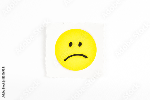 Photography Frowning face emoji note message on white background paper desk
