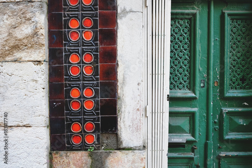Traditional wooden door and ceramic tiles mosaic wall in Lisbon, Portugal