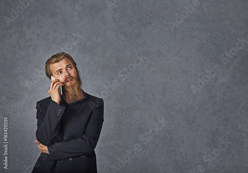 businessman talking on phone thinking isolated grey background