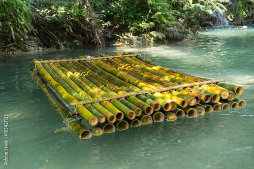 Bamboo raft in river. Selective focus. photo