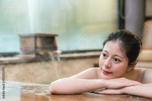 japanese girl takes a rest lying down on poolside