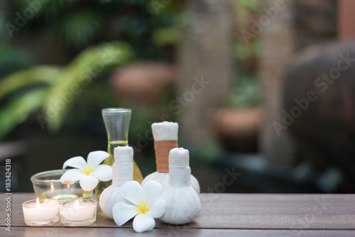 Thai spa massage compress balls and salt spa objects on textile background, wellness and relaxation concept