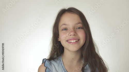 Beautiful happy teenage girl smiling close-up on white background stock footage video