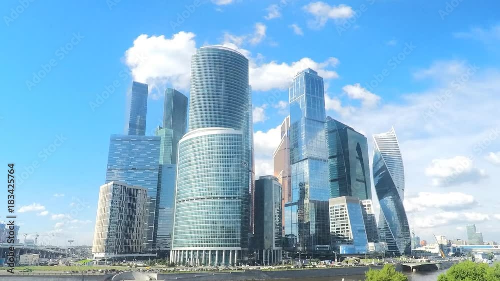 modern glass skyscrapers on river bank in summer timelapse modern glass skyscrapers on river bank in summer timelapse