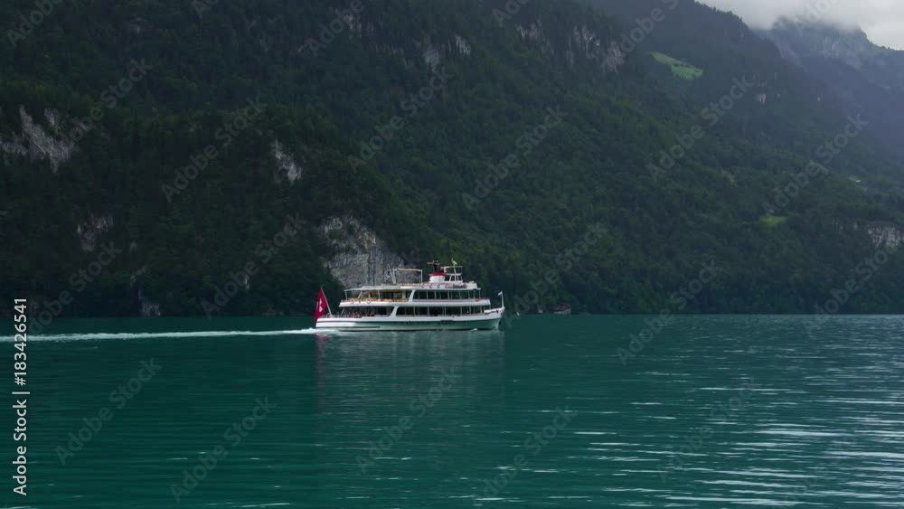 Swiss passenger boat cruising in Interlaken region of the Swiss Alps in Interlaken Switzerland Swiss passenger boat cruising in Interlaken region of the Swiss Alps in Interlaken Switzerland