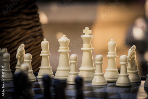 Black and White King and Knight of chess battle on board . Black king are leader to fight with teamwork to victory.  Leader and teamwork concept for success.