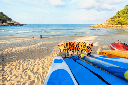 Blue kayaks and orange safety jackets on the tropical beach, Thailand