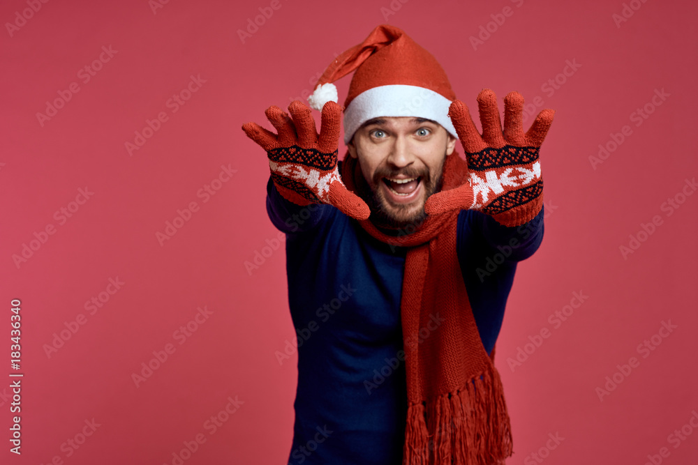 man pulls his hands in gloves forward, red background, free space for copying, christmas, new year, holiday man pulls his hands in gloves forward, red background, free space for copying, christmas, new year, holiday