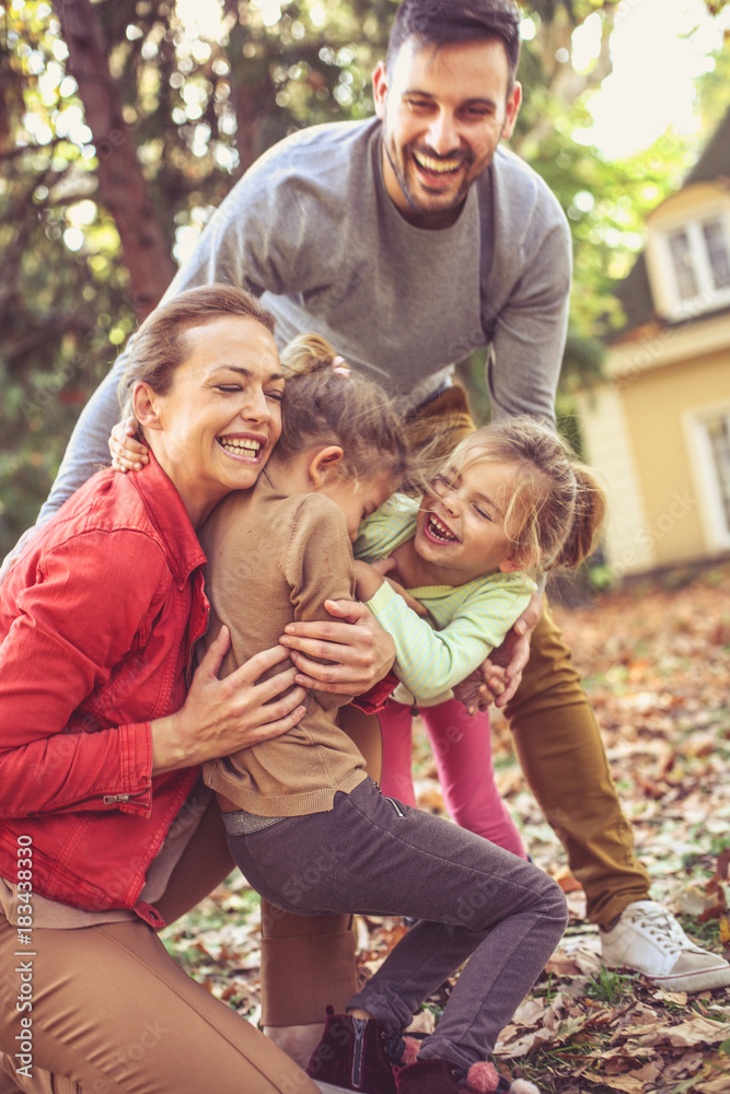 Happy family hugging itch other, autumn season in backyard. Happy family hugging itch other, autumn season in backyard.