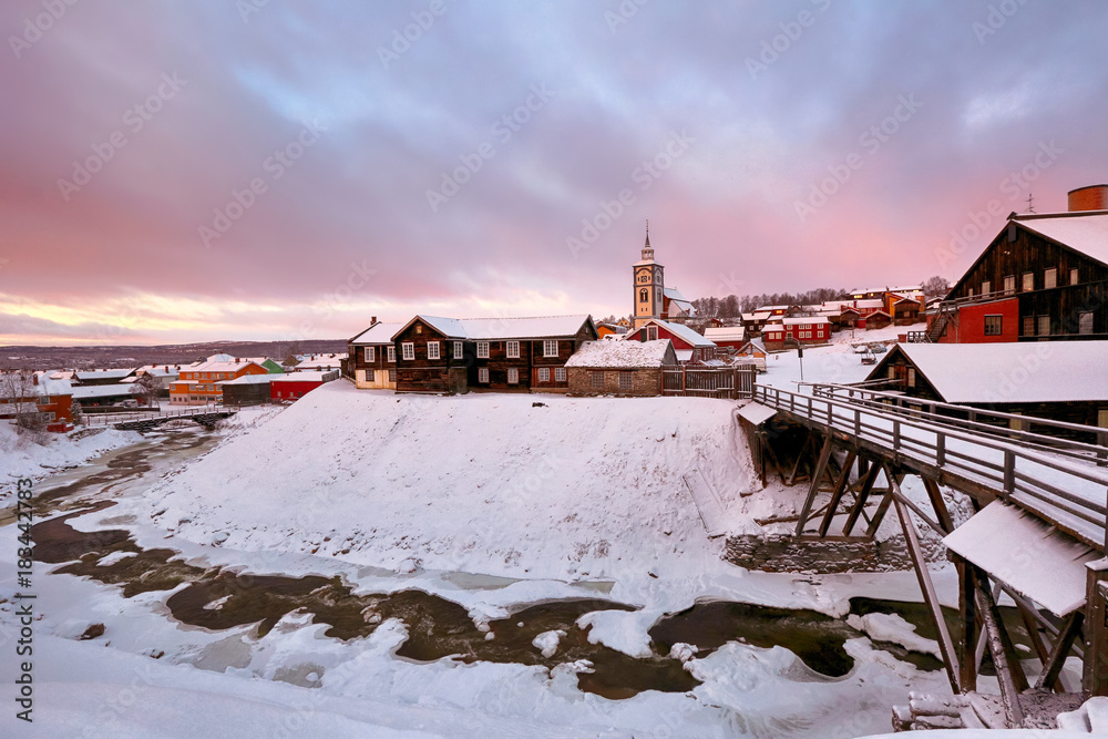 Winter in the norwegian town Roeros. The view of historical center during cold winter sunrise 