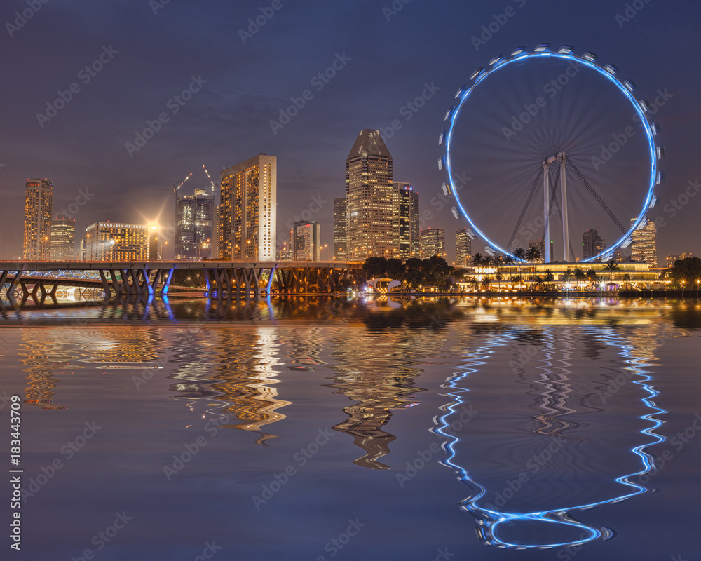 Singapore Flyer and Skyline reflected in the waters of Marina Bay