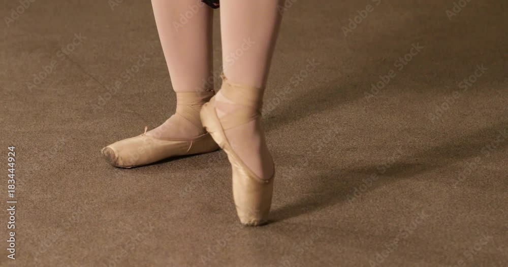 Close up of a ballet dancer's feet as she practices point exercises Close up of a ballet dancer's feet as she practices point exercises