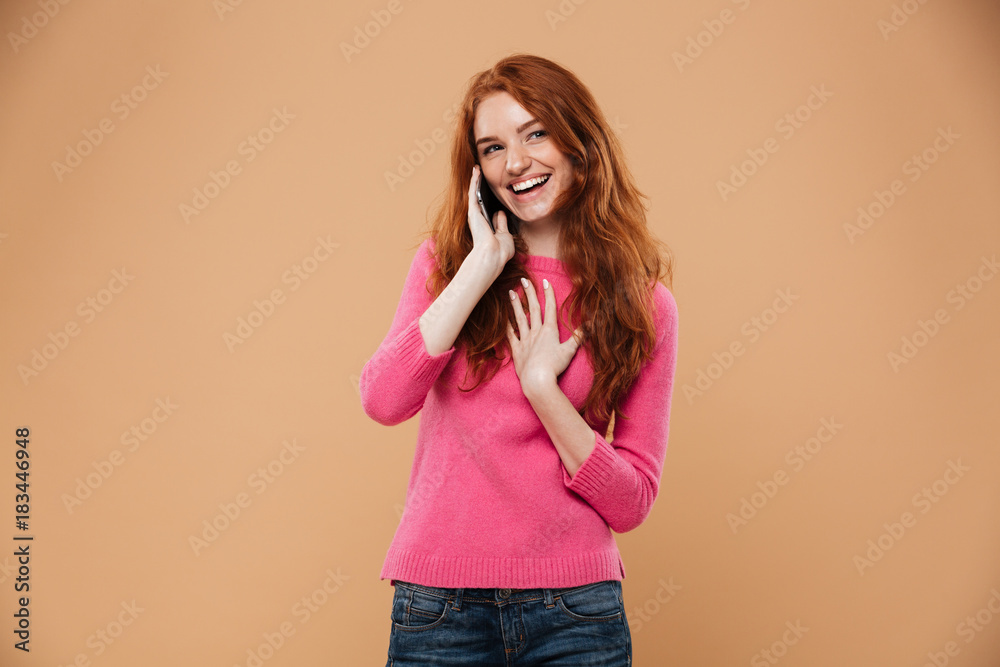 Portrait of a happy redhead girl talking on mobile phone Portrait of a happy redhead girl talking on mobile phone