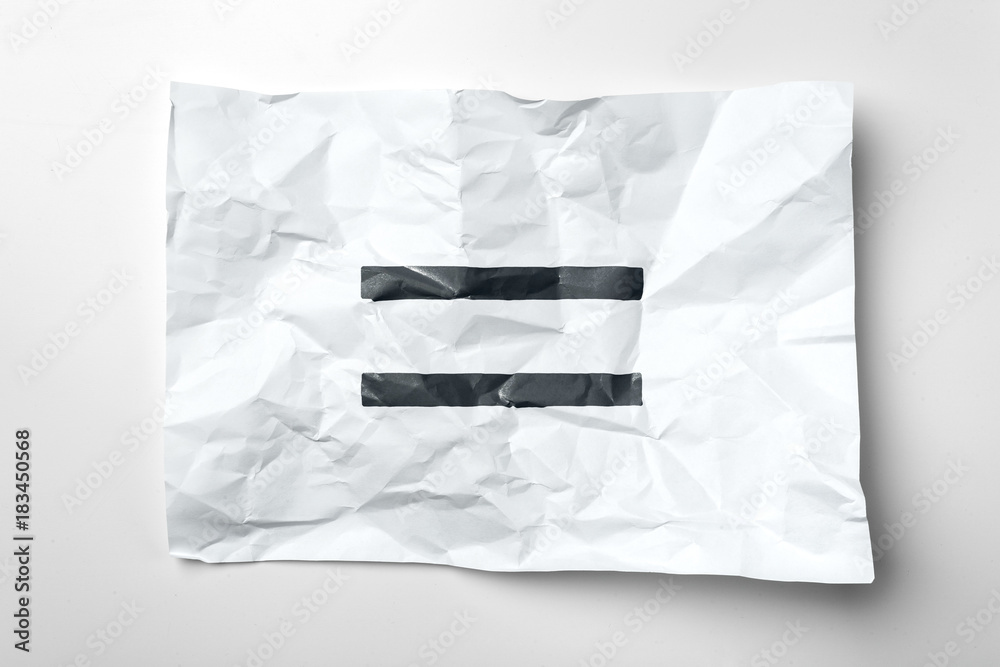Fototapeta premium Equal sign on a crumpled paper