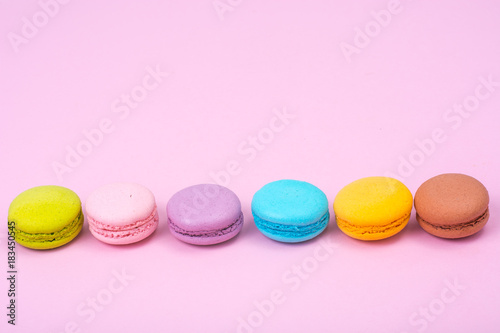 Small French macaroons on pastel background