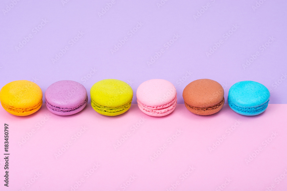 Small French macaroons on pastel background Small French macaroons on pastel background