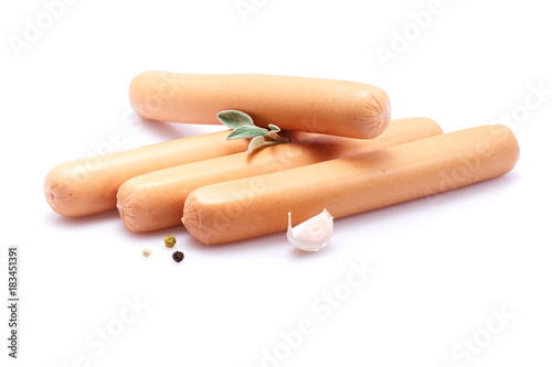 Frankfurter sausage isolated on white background with herbs and peppercorns