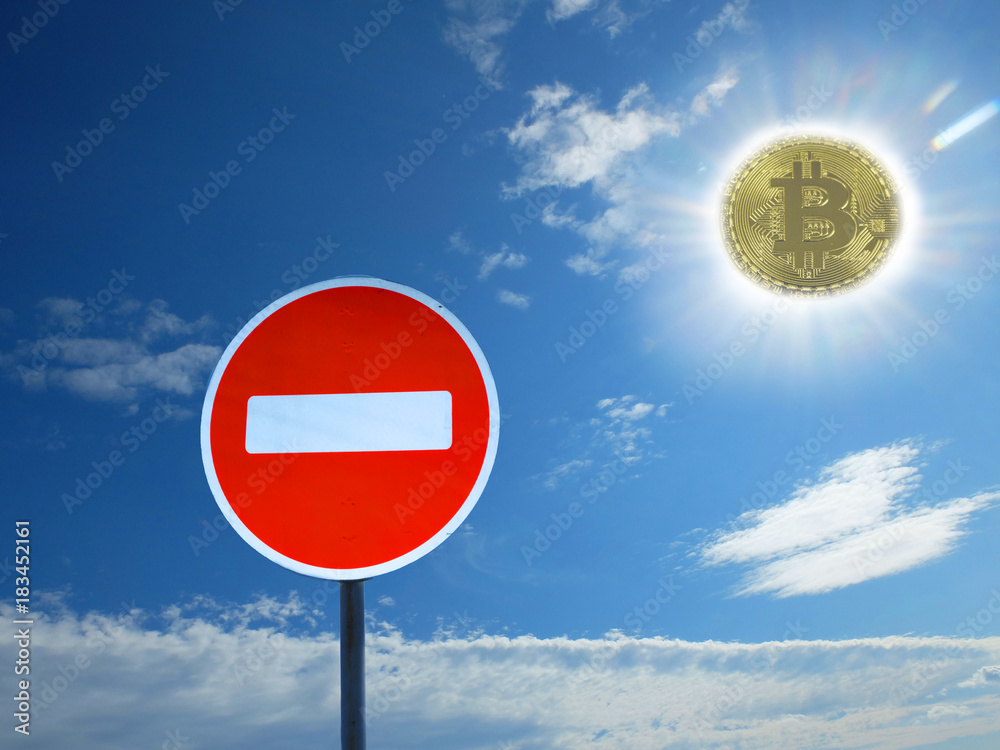 traffic sign no entry on the background of sky with clouds and coins of bitcoin is the sun. The prohibition of bitcoin. Ban cryptocurrencies. traffic sign no entry on the background of sky with clouds and coins of bitcoin is the sun. The prohibition of bitcoin. Ban cryptocurrencies.