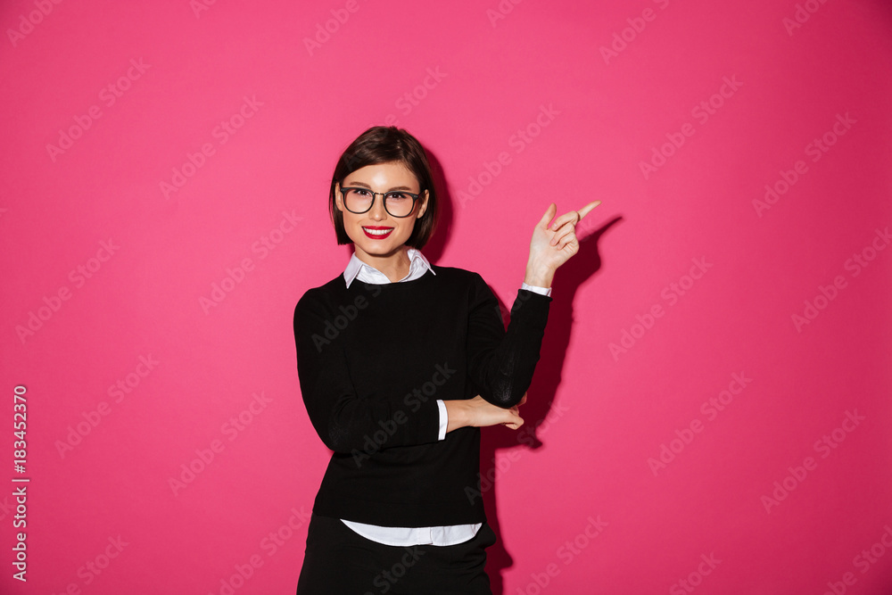 Pretty smiling woman pointing at copy space isolated Pretty smiling woman pointing at copy space isolated