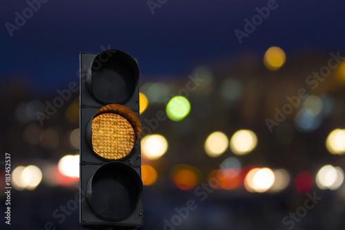 Car yellow traffic light at night with the timer on the background of the car. Night crossroad.