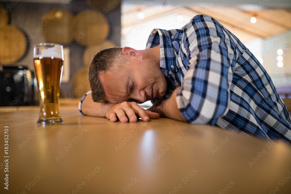 Drunken man sleeping on bar counter Drunken man sleeping on bar counter