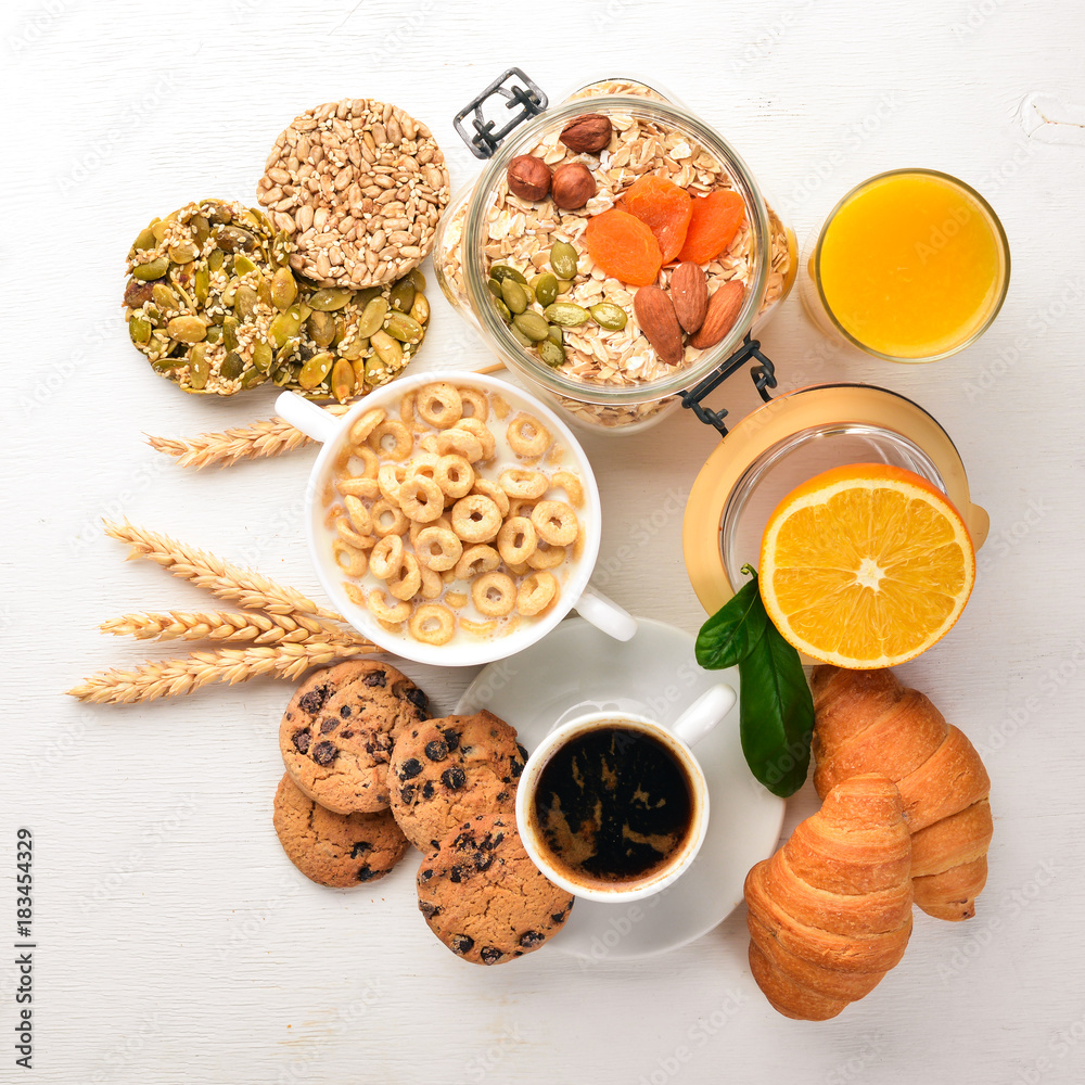 A healthy breakfast. Orange juice, kiwi, croissants, cookies, coffee, on a wooden surface. Top view. Free space for text. A healthy breakfast. Orange juice, kiwi, croissants, cookies, coffee, on a wooden surface. Top view. Free space for text.
