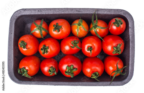 Small cherry tomatoes in black plastic mold photo