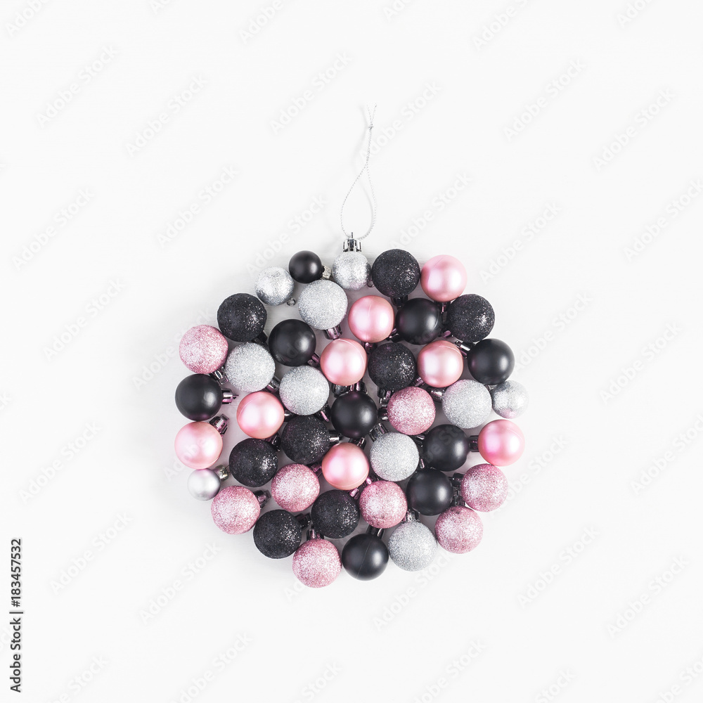 Christmas ball made of black, silver and pink balls on white background. Christmas, winter, new year concept. Top view, flat lay, square