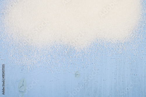 White sugar on a wooden background