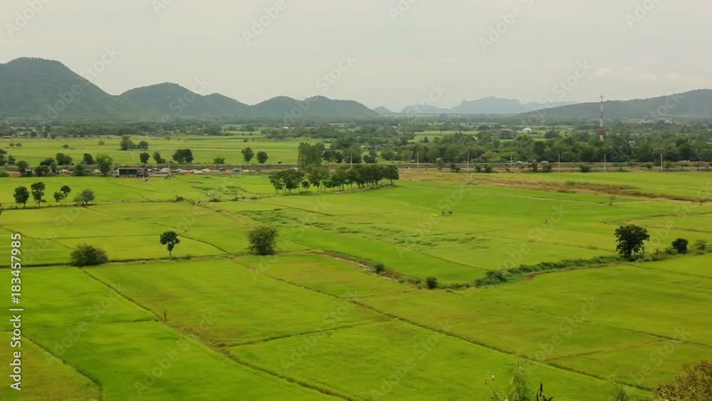 Landscape of a beautiful green rice paddy field and mountains. Kanchanaburi Province, Thailand. Landscape of a beautiful green rice paddy field and mountains. Kanchanaburi Province, Thailand.