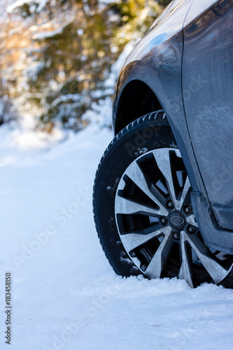 Winter tire. Closeup on SUV tire in snowy winter conditions.