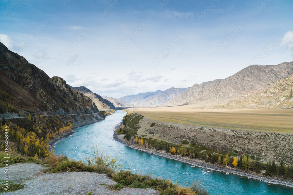 Mountainous summer landscape with a turquoise river.