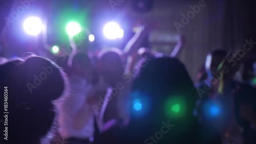 Footage of people crowd partying at a concert. Lot of people clapping at party.